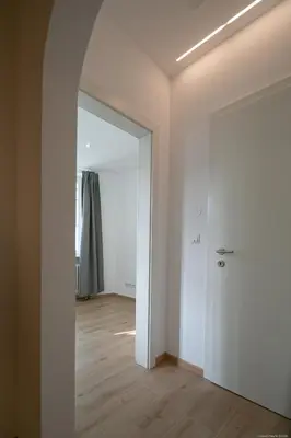 an empty room with a door and a hallway at Apartment Central in Bolzano