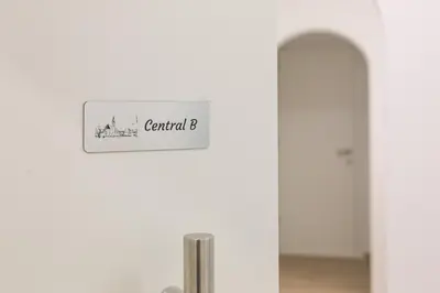 a sign on a white wall in a room at Apartment Central in Bolzano