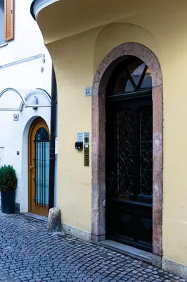 an entrance to a building with two black doors at Apartment Central in Bolzano