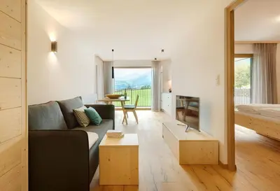 a living room with a couch and a table at Ariala - Mountain Holiday Home in Falzes