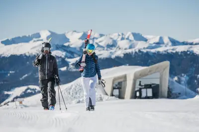 two people are standing in the snow with skis at Ariala - Mountain Holiday Home in Falzes