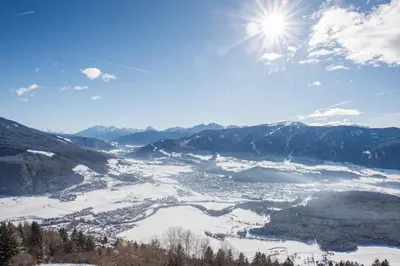 a view of a valley in the snow with the sun at Ariala - Mountain Holiday Home in Falzes