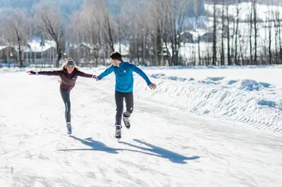 a man and a woman running in the snow at Ariala - Mountain Holiday Home in Falzes