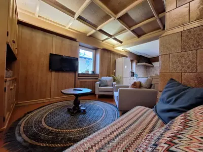a living room with a bed and a table at Villa Noce 2 in Tesero