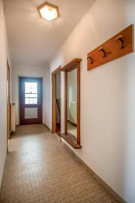 a hallway with two mirrors on a wall at Villa Noce 1 in Tesero