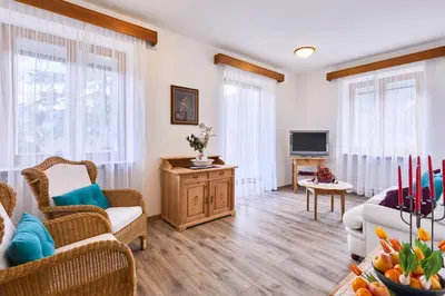 a living room with a couch and a tv at Apartmenthaus Haringer in Novacella
