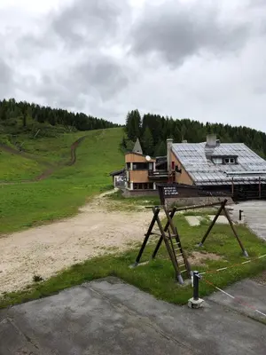 a house with a metal roof on top of a field at Mellon House in Falcade