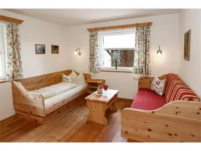 a living room with a couch and a table at Bio Kräuterhof Oberpalwitter in Barbiano