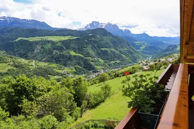 a balcony with a view of a valley and mountains at Bio Kräuterhof Oberpalwitter in Barbiano