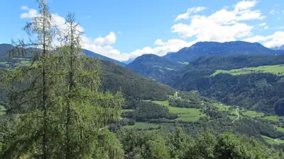 a view of a valley in the mountains at Bio Kräuterhof Oberpalwitter in Barbiano