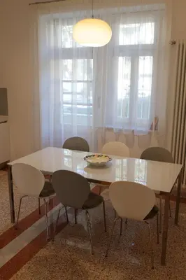 a dining room table and chairs with a white table at Delightful Villa Rina in Merano