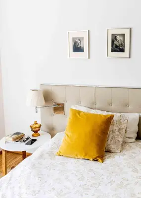a bedroom with a bed with a yellow pillow on it at Delightful Villa Rina in Merano