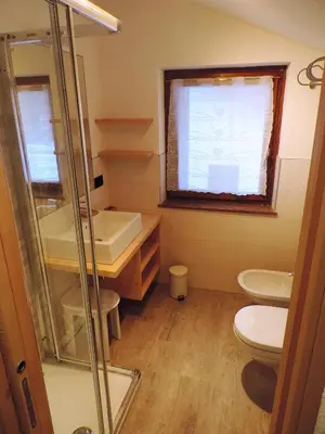 a bathroom with a toilet and a sink at incantevole mansarda in val di Fassa in Alba di Canazei