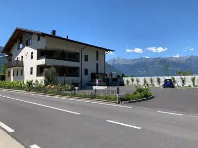 a white building on the side of a road at Apartments ANNY in Postal