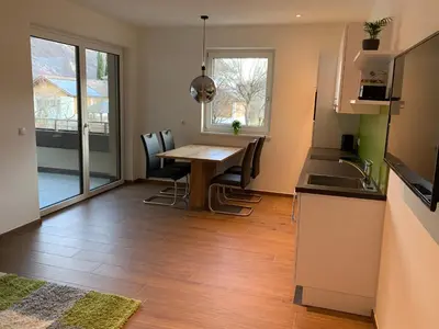 a kitchen and dining room with a table and chairs at Apartments ANNY in Postal