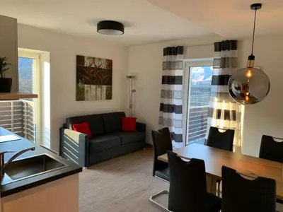 a living room with a couch and a table at Apartments ANNY in Postal