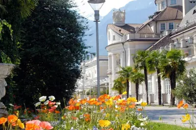 a garden of flowers in front of a building at Relax Suite in Merano