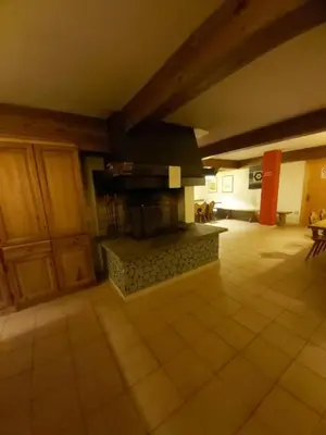 a living room with a fireplace in the middle at Casa Cavalese sul Cermis in Cavalese