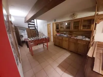 a kitchen with a table in the middle of a room at Casa Cavalese sul Cermis in Cavalese