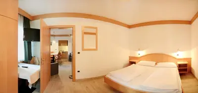 a bedroom with a large bed in a room at Casa Roder by Garni Snaltnerhof in Ortisei