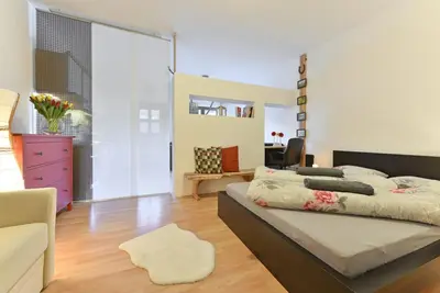 a bedroom with a large bed and a living room at Ebenhof in Collepietra
