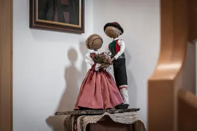 a couple of dolls sitting on top of a table at Baumannhof in Schenna