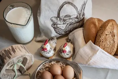 a table with eggs and bread and a basket of milk at Baumannhof in Schenna