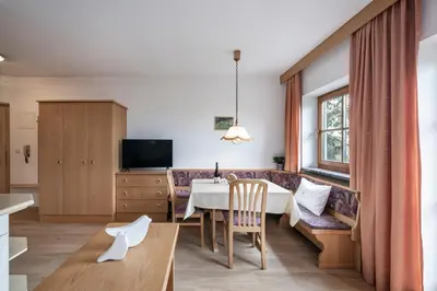 a living room with a table and a couch at Baumannhof in Schenna