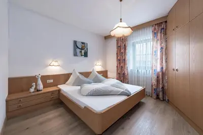 a bedroom with a bed and a window at Baumannhof in Schenna