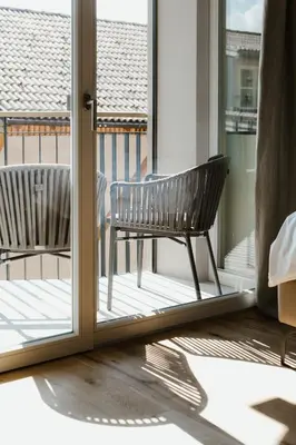 a balcony with a bench in front of a door at Ansitz am Eck by Hotel Pernhof in Termeno