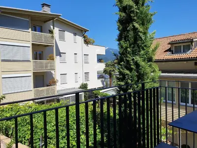 a balcony with a black fence and a building at Ansitz am Eck by Hotel Pernhof in Termeno