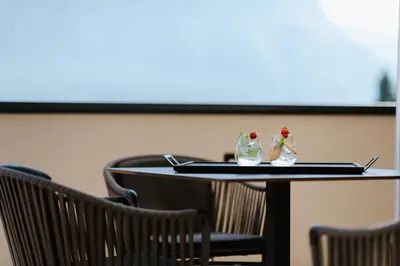 a table with two glass bottles on top of it at Ansitz am Eck by Hotel Pernhof in Termeno