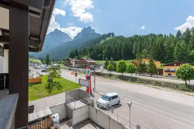 a car is parked at a gas station on a street at Casa Rosi in Pozza di Fassa