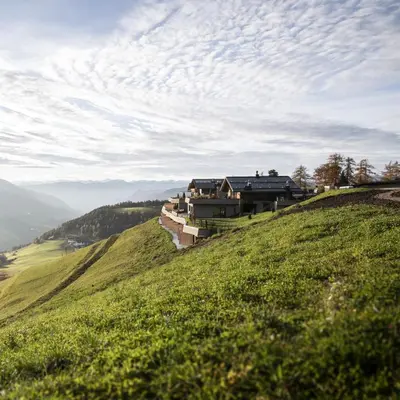 a house on the side of a grassy hill at Gfell in Vols am Schlern