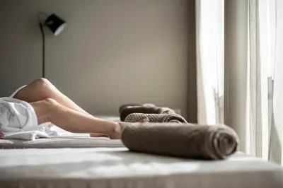 a woman laying on a bed with her legs crossed at Gfell in Vols am Schlern