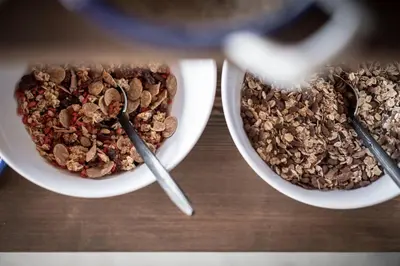 two bowls of granola and two spoons on a table at Gfell in Vols am Schlern
