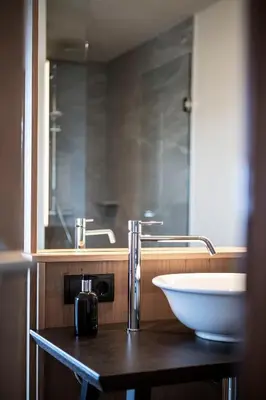 a bathroom with a white sink and a mirror at Gfell in Vols am Schlern