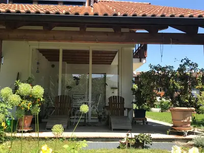 a screened in porch with two chairs and a table at Haus Greti in Magrè allʼ Adige