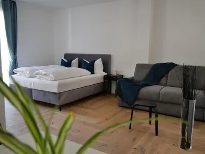a living room with a couch and a couch and a chair at Apartments Sabine G in Merano