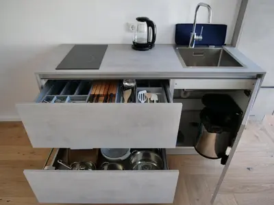 a kitchen counter with a sink and a drawer at Apartments Sabine G in Merano