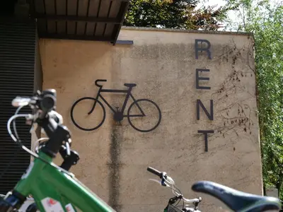 a sign with a bike on the side of a building at Apartments Sabine G in Merano
