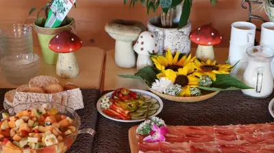 a table topped with plates of food and mushrooms at B&B Brunnerhof in Feldthurns