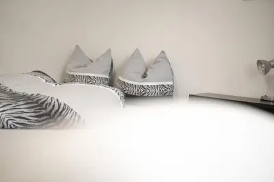 a row of pillows sitting on a wall at Village Charme in Molini di Tures