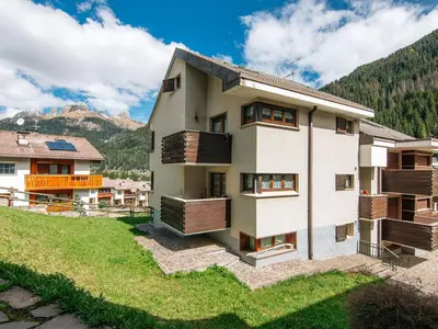 a mountain covered in snow with trees in the foreground at Apartment Enrosadira-7 by Interhome in Alba di Canazei