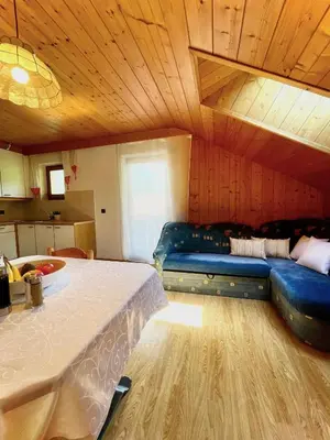 a bedroom with a blue couch in a room at Apartments Spirit of Mountains in Rasun di Sopra