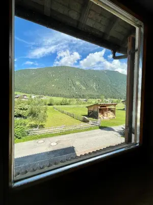 a view of a field from a window at Apartments Spirit of Mountains in Rasun di Sopra