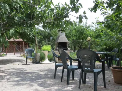 a group of chairs and a table with a fireplace at Agritur al Canyon in Cloz