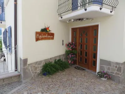 a front door of a building with a sign on it at Agritur al Canyon in Cloz
