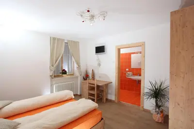 a room with a bed and a bathroom at Agritur al Canyon in Cloz