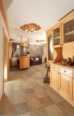 a large living room with a tiled floor at Agritur al Canyon in Cloz